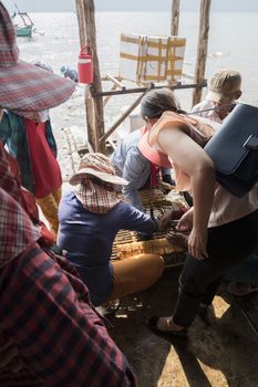 Krong Kaeb, Kep Province, Cambodia, 30 March 2018. Woman buying crabs at the Crab Market