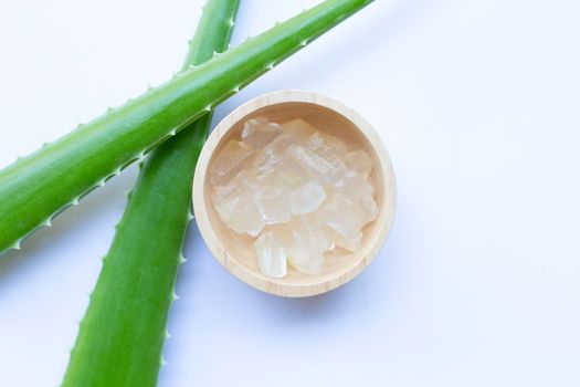 Aloe vera gel in wooden bowl on white background. Copy space