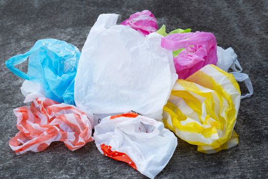 Colorful plastic bags on cement floor background