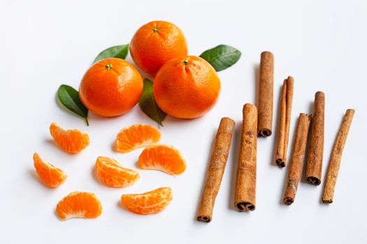 Mandarin orange with cinnamon stick on white Background