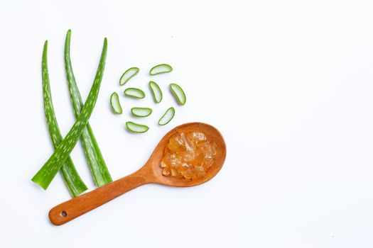 Aloe vera gel on wooden spoon with aloe vera on white background