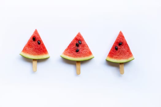Sweet watermelon slice popsicles on white background