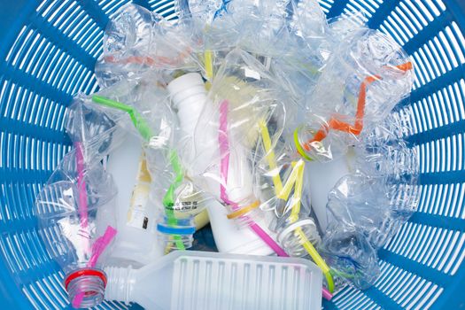 Plastic waste, Plastic bottles with straws in waste basket