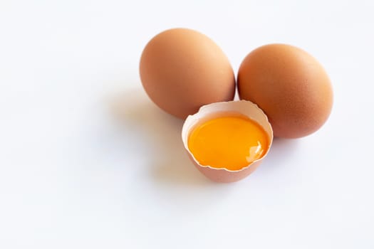 Chicken eggs with yolk on white background.