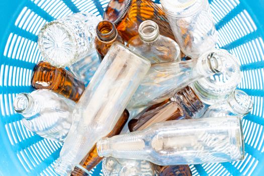 Glass bottles in waste basket. Top view