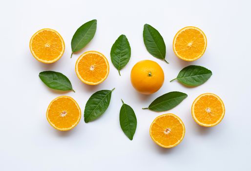 Oranges and green leaves on white background.