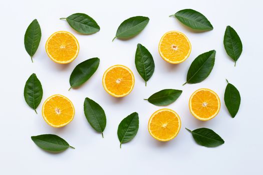 Oranges and green leaves on white background.