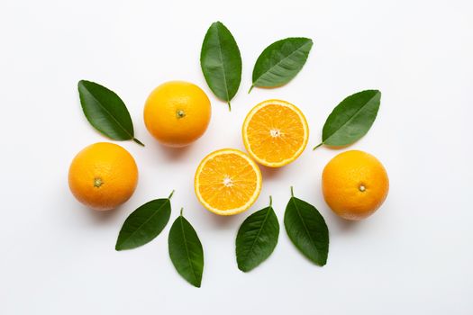 Oranges and green leaves on white background.