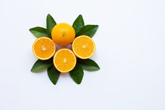 Oranges and green leaves on white background.