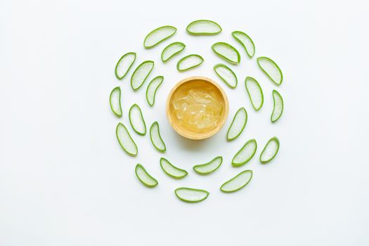 Aloe vera slices with aloe vera gel on wooden bowl isolated on white  background.