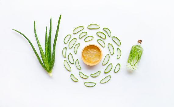 Aloe vera with slices and extract on white background.