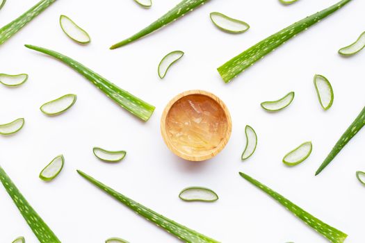 Aloe vera gel in wooden bowl with aloe vera leaves and slices  on a white background.