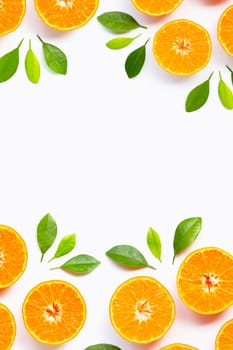 Frame made of Orange with green leaves isolated on white background. Copy space