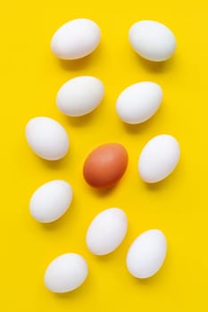 Fresh eggs on yellow background.  Top view