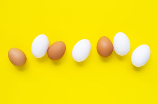 Eggs on yellow background. Top view
