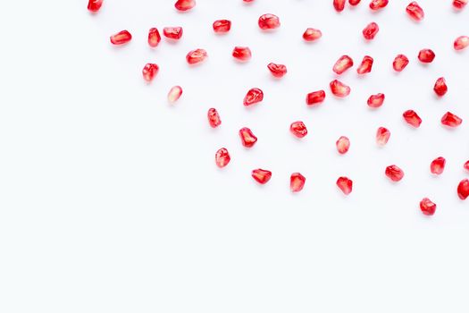 Pomegranate seeds on white background. Copy space