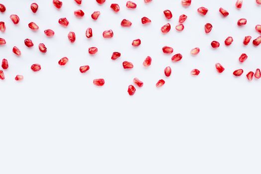 Pomegranate seeds on white background. Copy space