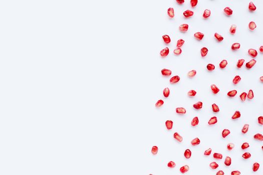 Pomegranate seeds on white background. Copy space