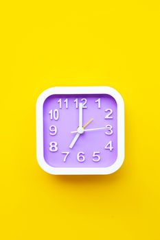 Clock on yellow background. Top view