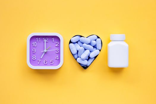 Clock with "PrEP" ( Pre-Exposure Prophylaxis). used to prevent HIV on yellow background. Top view