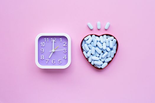 Clock with "PrEP" ( Pre-Exposure Prophylaxis). used to prevent HIV on pink background. Top view