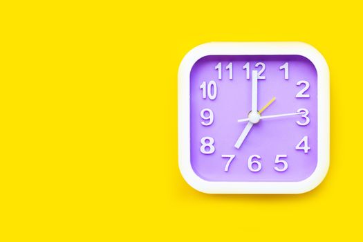 Clock on yellow background. Copy space