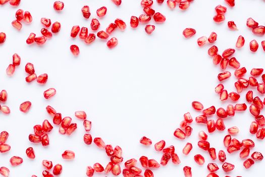 Frame made of pomegranate seeds isolated on white background. Copy space