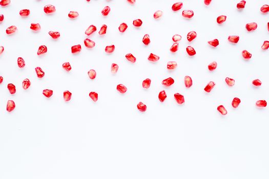 Pomegranate seeds on white background. Copy space