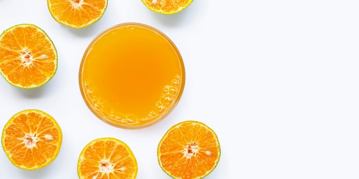 Glass of fresh orange juice on white background. Top view with copy space