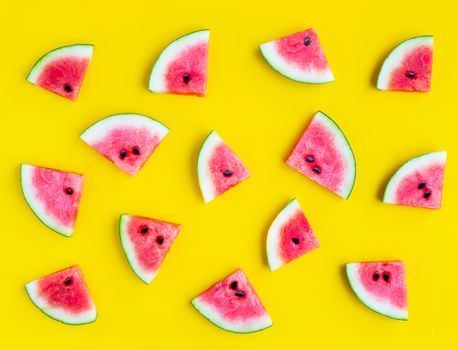 Slices of watermelon on yellow background. Top view