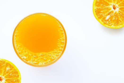 Glass of fresh orange juice on white background. Top view with copy space