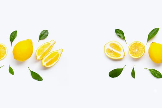 Fresh lemon with green leaves on white background.
