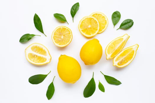 Fresh lemon with green leaves on white background.