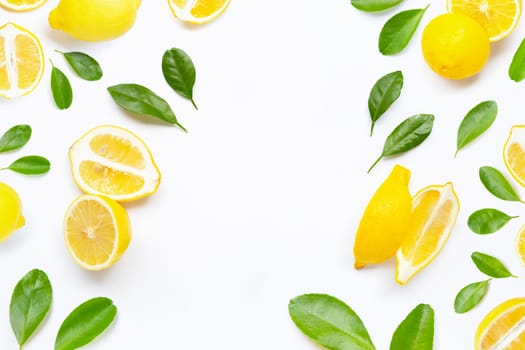 Frame made of fresh lemon with green leaves on white background.