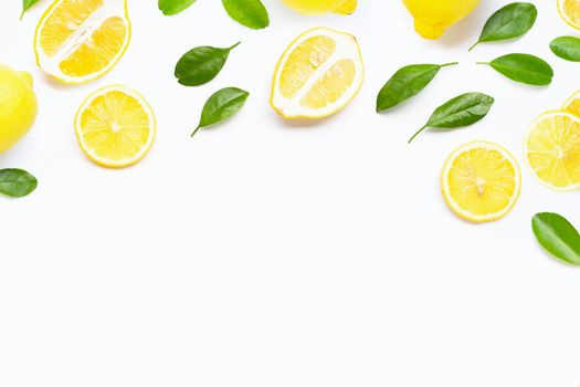 Fresh lemon with green leaves on white background.