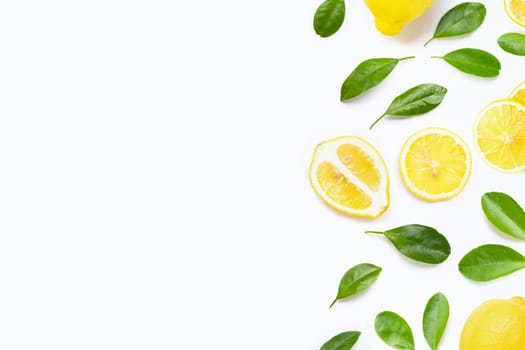 Fresh lemon with green leaves on white background.