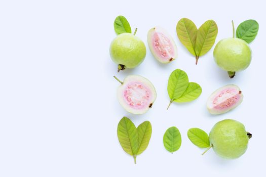 Top view of fresh ripe guava and slices with leaves on white background. Copy space