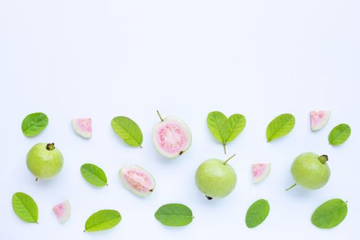 Top view of fresh ripe guava and slices with leaves on white background. Copy space