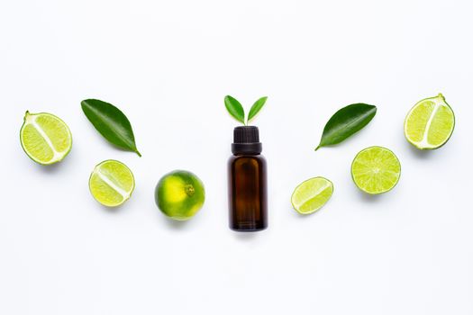 Essential oil with Limes and leaves isolated on white background.