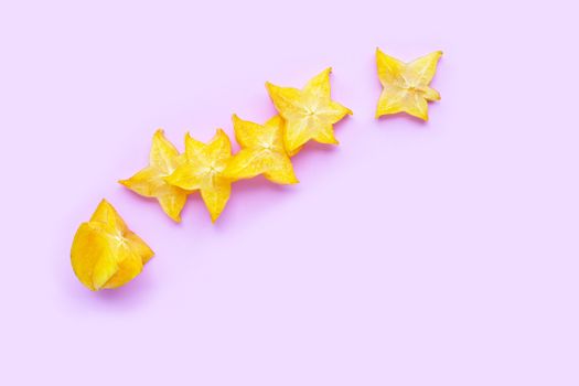 Ripe star fruit on pink background.  Top view