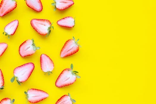Ripe strawberries on yellow background. Copy space