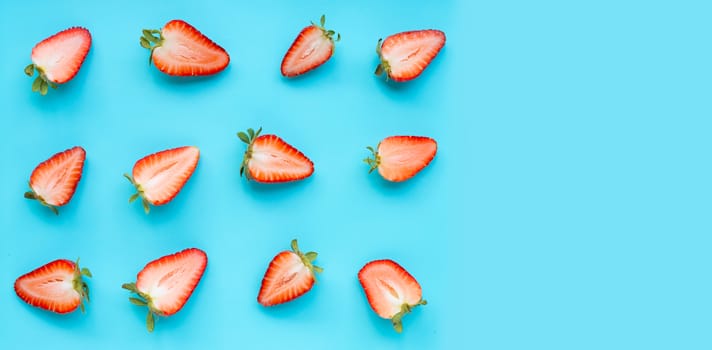 Ripe strawberries on blue background. Copy space