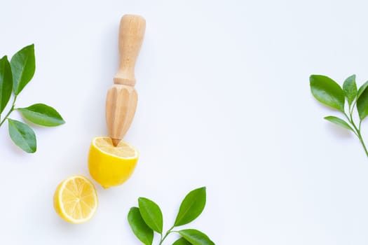Fresh lemon and leaves with wooden juicer on white background.  Copy space