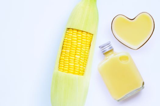Fresh corn with  sweet corn juice or corn milk on white background. Copy space