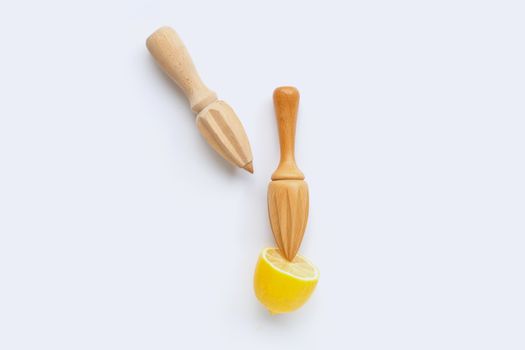 Fresh lemon with two wooden juicer on white background.  Copy space