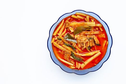 Red curry preserved bamboo shoot with pork, white background.