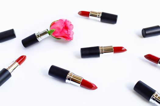 Lipsticks with rose flower on  white background. Beautiful Make-up concept