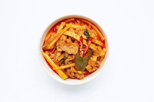 Red curry preserved bamboo shoot with pork, white background.
