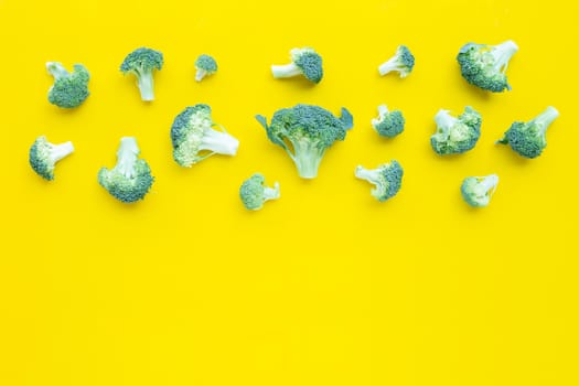 Fresh broccoli on yellow background. Copy space