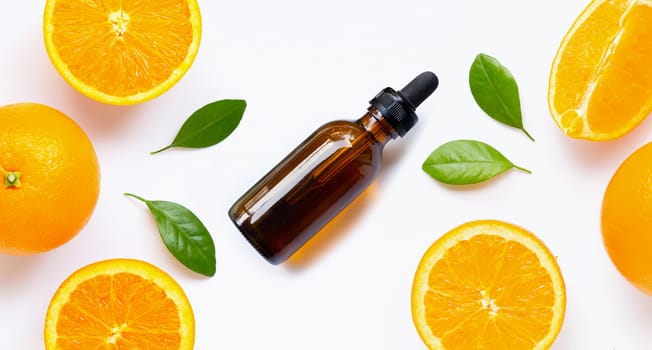 Essential oil with fresh orange citrus fruit with leaves isolated on white background. 